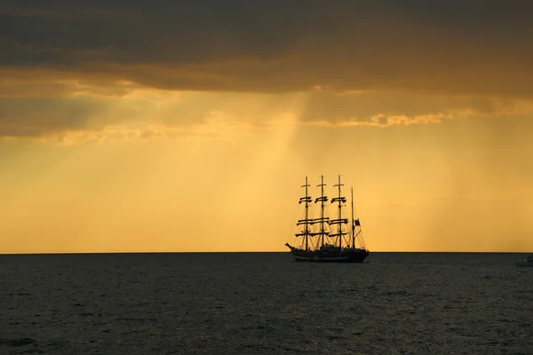 Silhouette of the tall ship at sunset