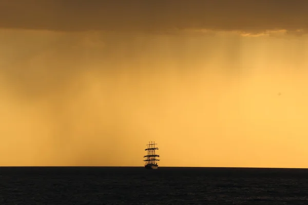 Silhouette of the tall ship at sunset