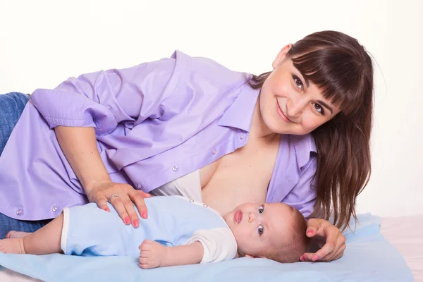Cute happy family mother mum breastfeeding baby boy girl on whit