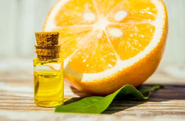 Lemon essential oil and lemon fruit on the wooden board, (taken with tilt shift lens)