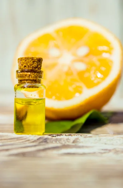 Lemon essential oil and lemon fruit on the wooden board, (taken with tilt shift lens)