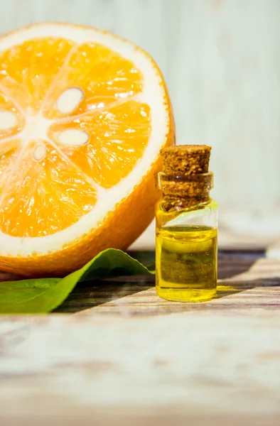 Lemon essential oil and lemon fruit on the wooden board, (taken with tilt shift lens)