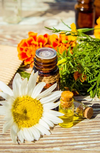 Small bottle of essential marigold oil (Tagetes flowers extract, tincture, infusion)