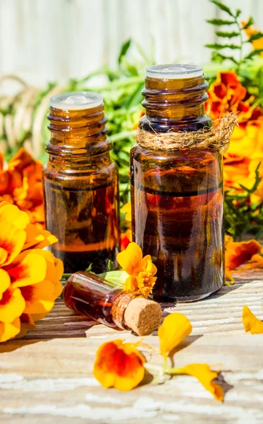 Small bottle of essential marigold oil (Tagetes flowers extract, tincture, infusion)