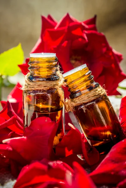 Rose essential oil in a small bottle of dark glass