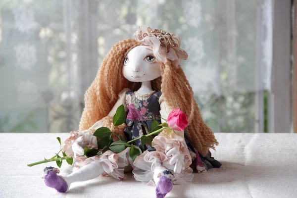Doll with long hair and a rose