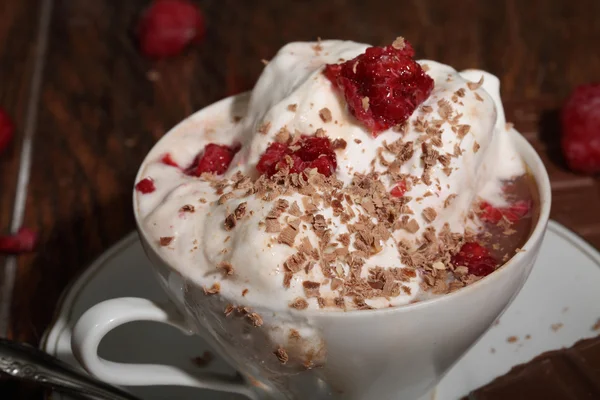 Coffee with ice-cream and a fresh raspberry
