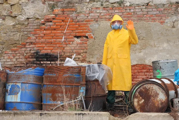 Man with protective mask and protective clothes explores danger area