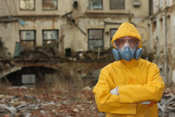 Man with protective  mask and protective  clothes  explores danger area