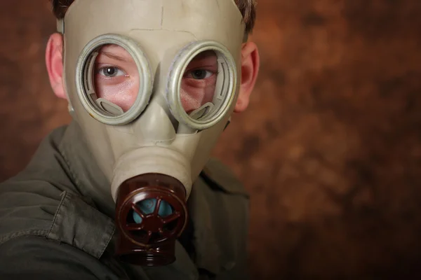 Man with gas mask on brown batik  background