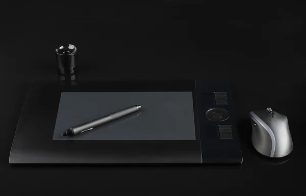 Graphic tablet and pen and stand for nibs and mouse on black