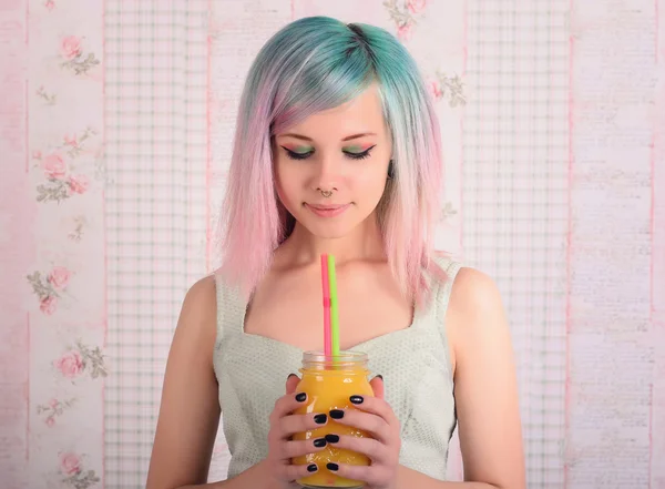 Closeup portrait - happy gorgeous fashionable young woman colorful hair. Teenage girl in dress holding jar of juice.