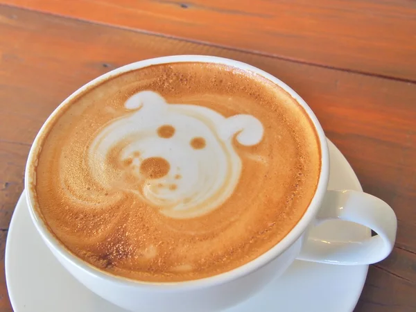 Latte Coffee art on the wooden desk.