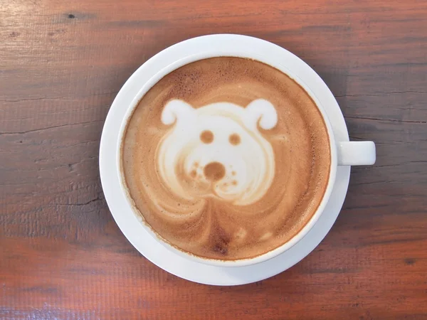 Latte Coffee art on the wooden desk.