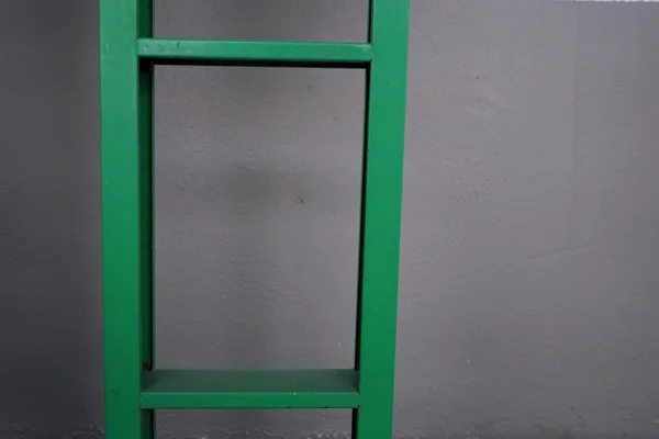 Green metal stairs with the white background