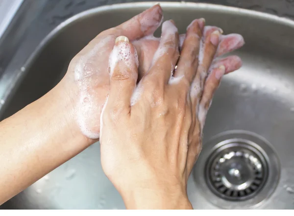 Washing of female hands with soap