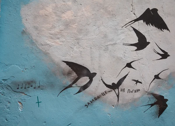 Lviv, Ukraine - October 18, 2015: Graffiti on the wall with the image of the birds and the inscription in Ukrainian \