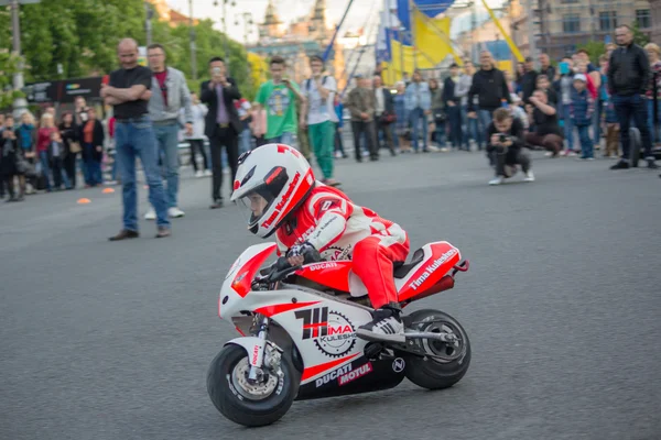 Kiev, Ukraine - May 01, 2016: Little driver demonstrates management skills motorcycle