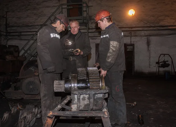 Zorinsk, Ukraine - March 18, 2013: Locksmiths repair of mining e