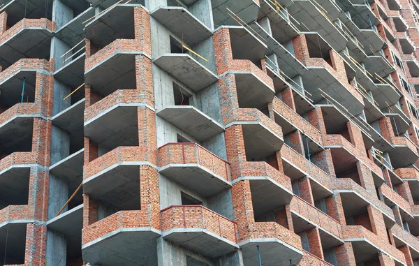 Facade of a block of flats under construction. Industry