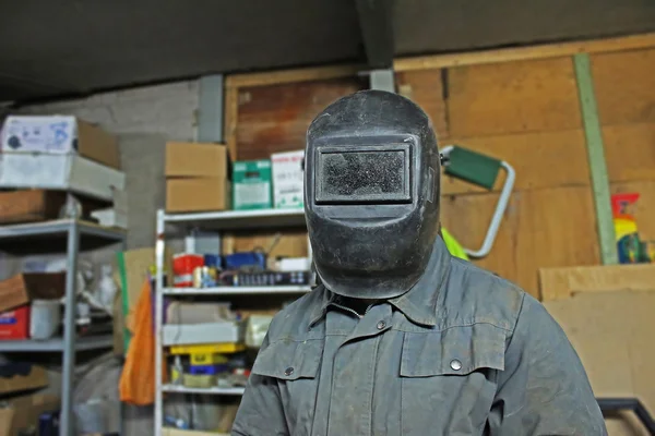 Welder in the mask in the workshop
