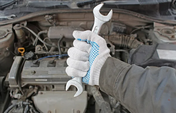 Wrench in the hand of auto mechanic