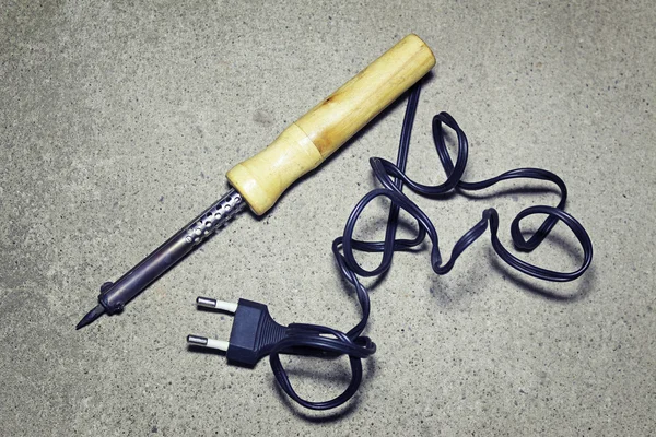 Soldering iron on a gray background