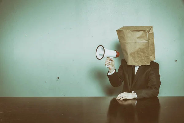 Businessman wearing paper bag in head