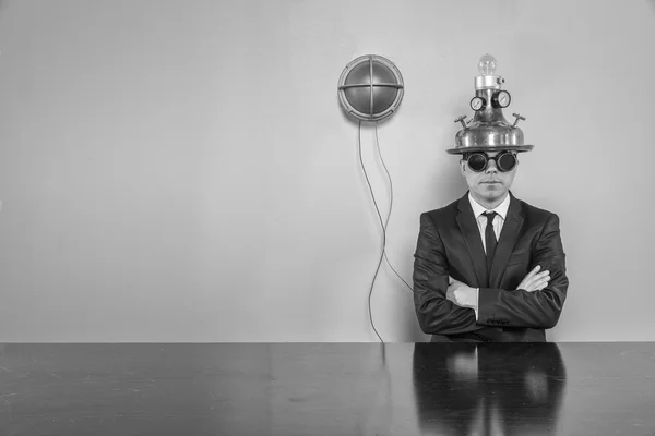 Vintage businessman with alert light sitting at office desk