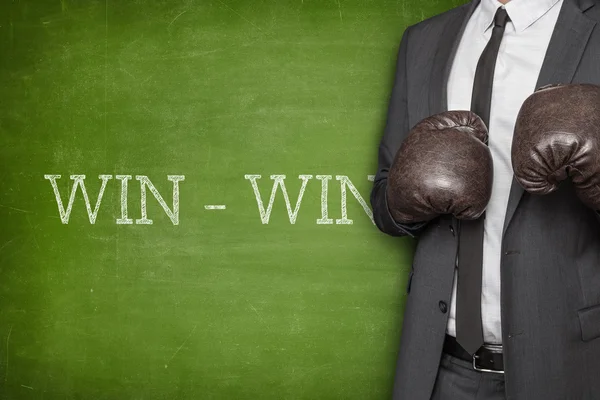 Win - win on blackboard with businessman on side