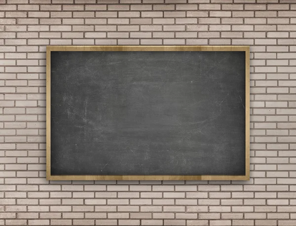 Black blank blackboard with wooden frame on brick wall background
