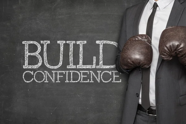 Build confidence on blackboard with businessman