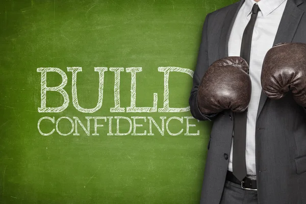 Build confidence on blackboard with businessman