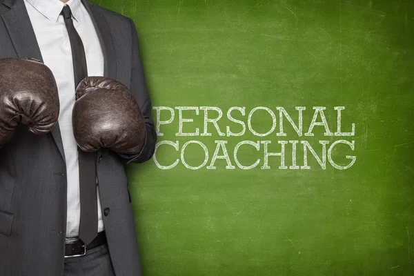 Personal coaching on blackboard with businessman on side
