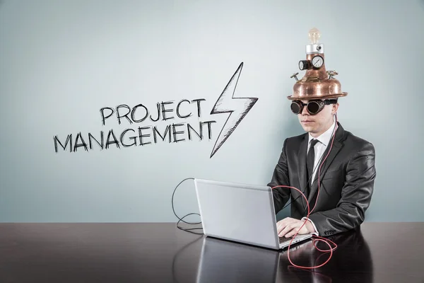 Project management concept with vintage businessman and laptop