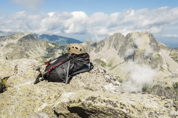 Helmet, backpack and trekking poles