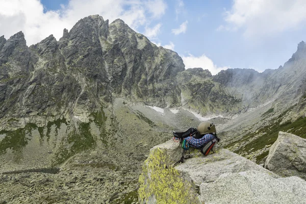 Dynamic rope, helmet, carabiners, climbing harness and descender on the rock in Tatra Valley