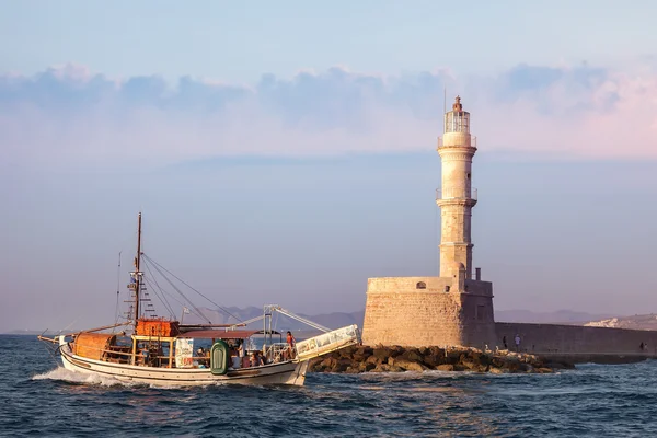 Famous lighthouse in Chania and pleasure boat, Greece