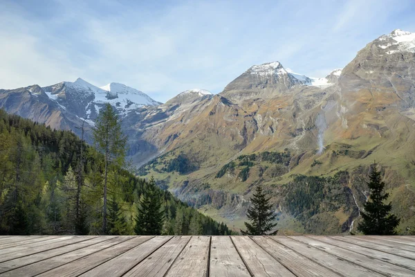 Empty wooden terrace with Austria national park view on background