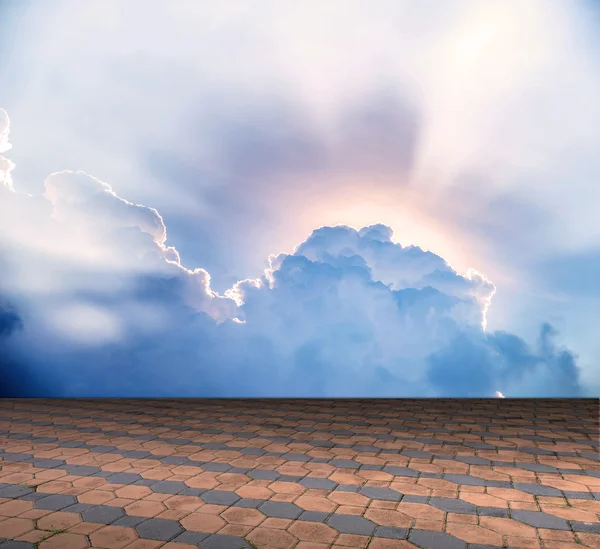 Cement brick floor with cloud and blue sky