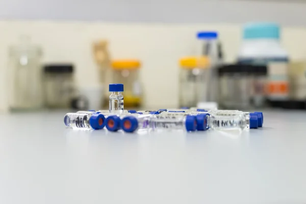 Used vials in the analytical instrument on the laboratory bench
