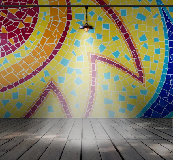 Lamp in Empty room with Colorful mosaic tile wall and Wood plank floor