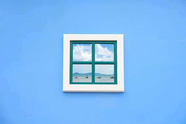 Round arch window on the blue wall