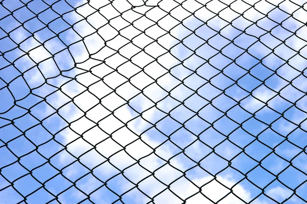 Silhouette wired fence with blur cloud and blue sky background