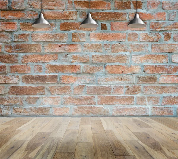 Lamp at brick wall background with ground wood