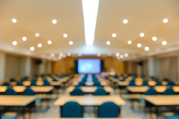 Empty meeting or conference room blurred for background.