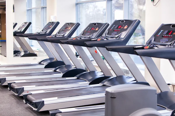 Set of treadmills staying in line in the gym