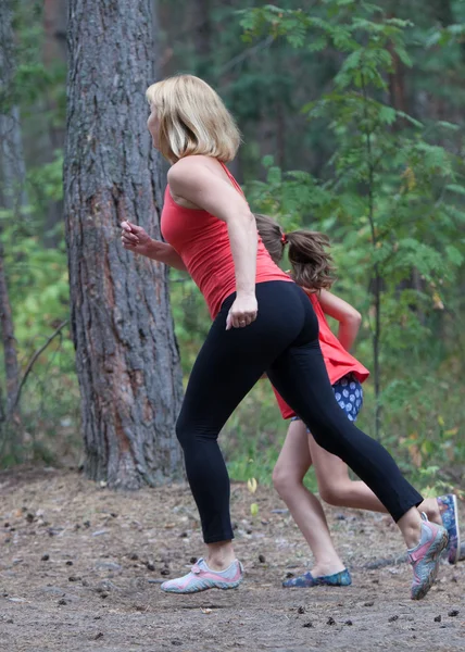 Fitness outdoors mom and daughter