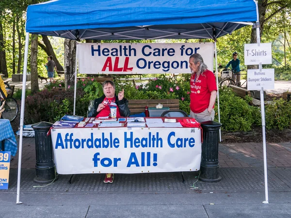 Health care policy volunteers staff booth at Corvallis Farmers M