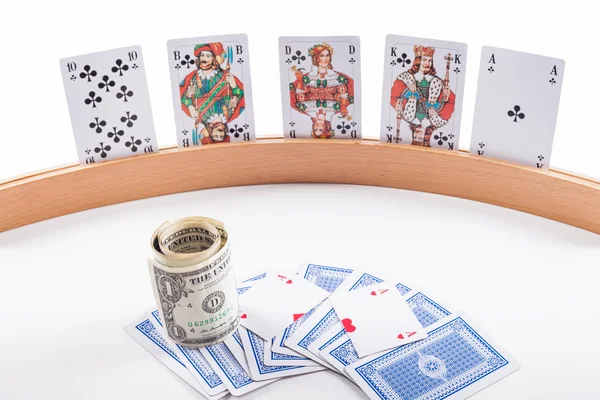 Playing card holder with playing cards and dollars